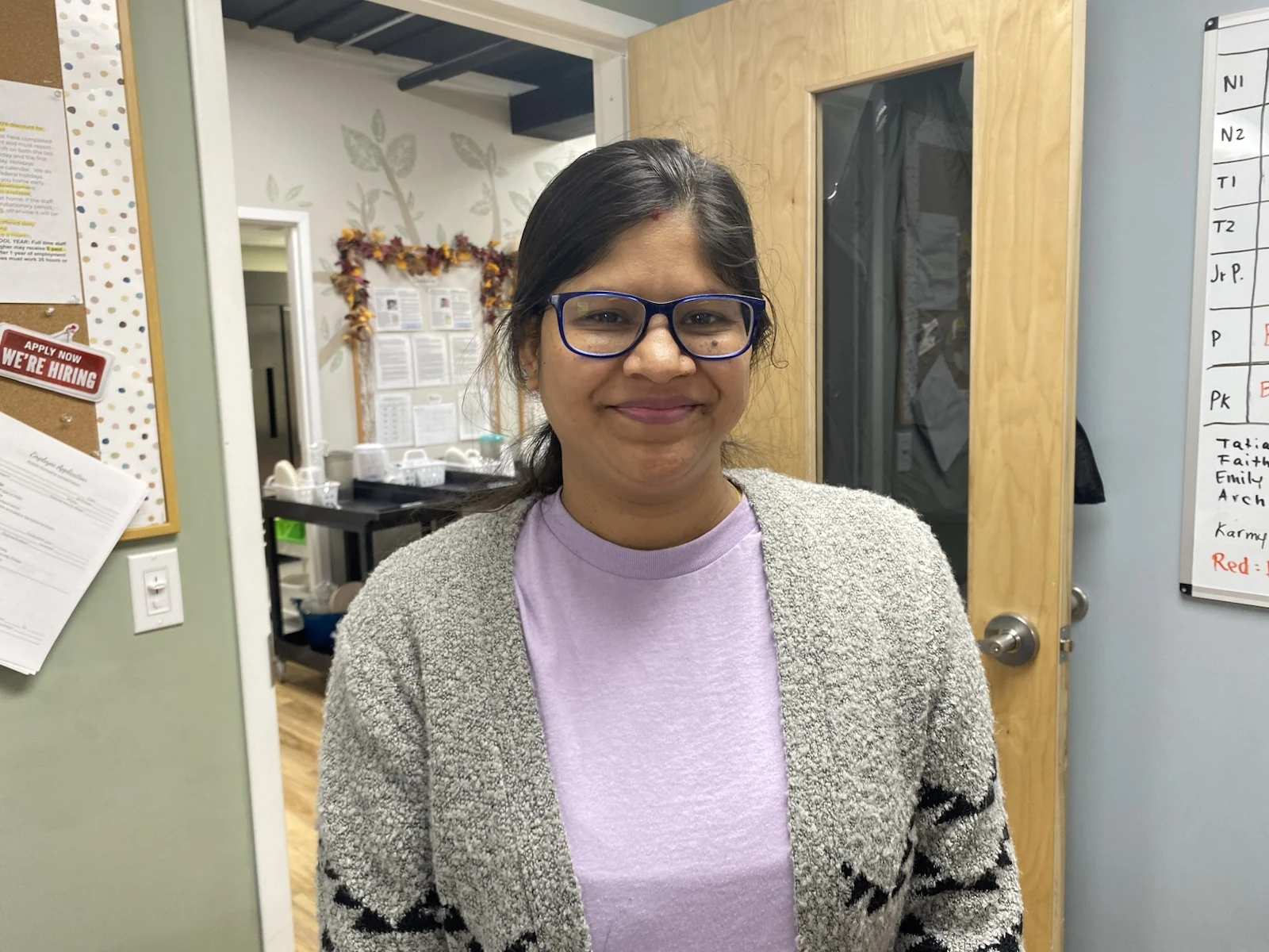 Ms. Archana smiling in a Wild Roots classroom