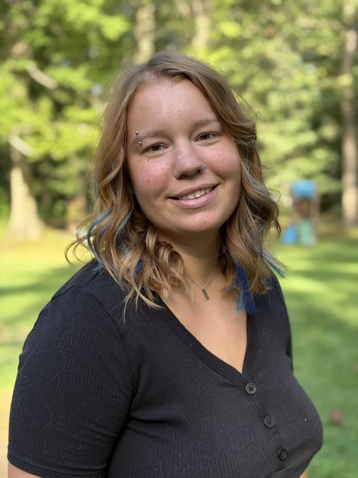 Ms. Ellen smiling outdoors
