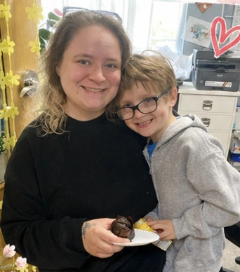 A Wild Roots family member and child smiling together